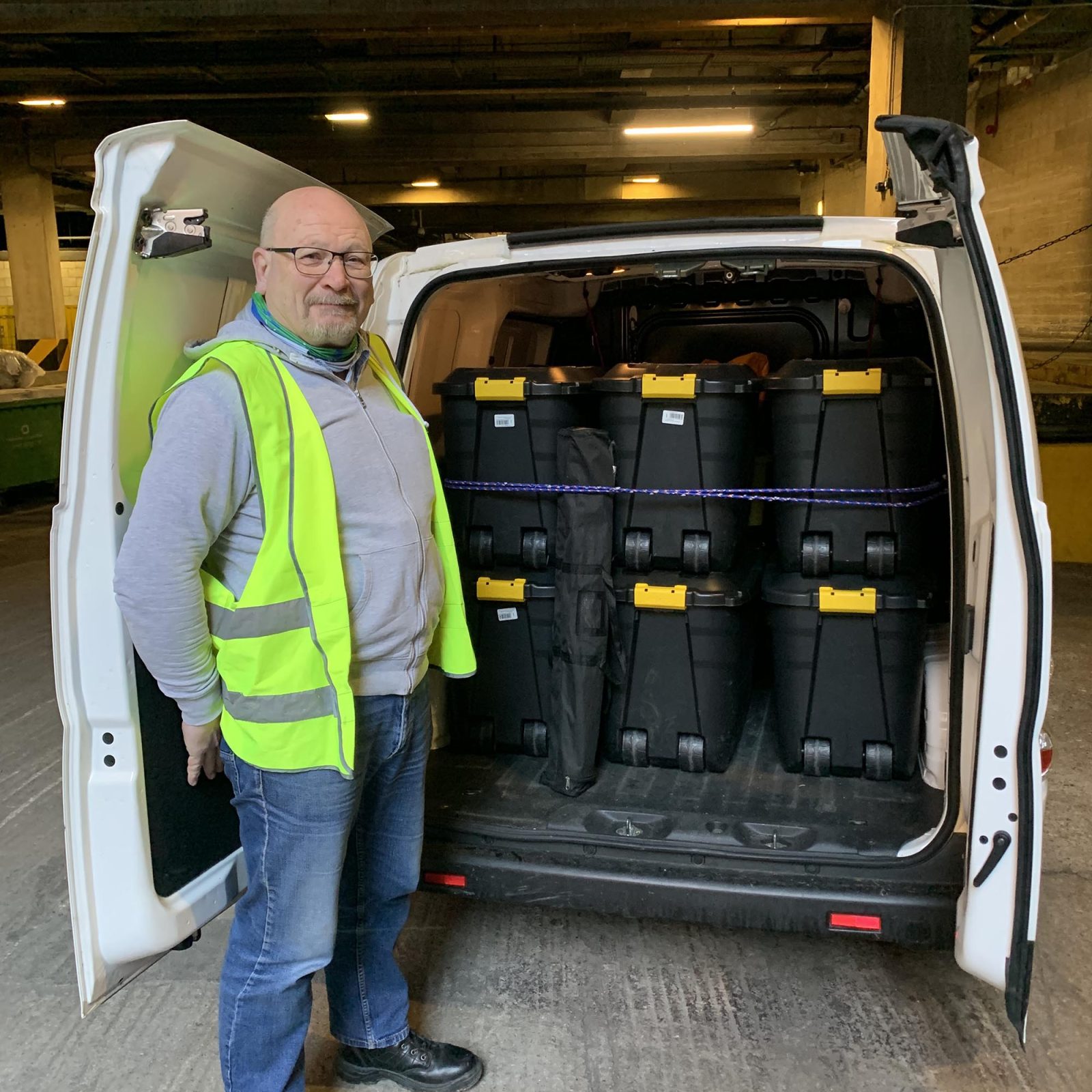 man standing at the back of an open van