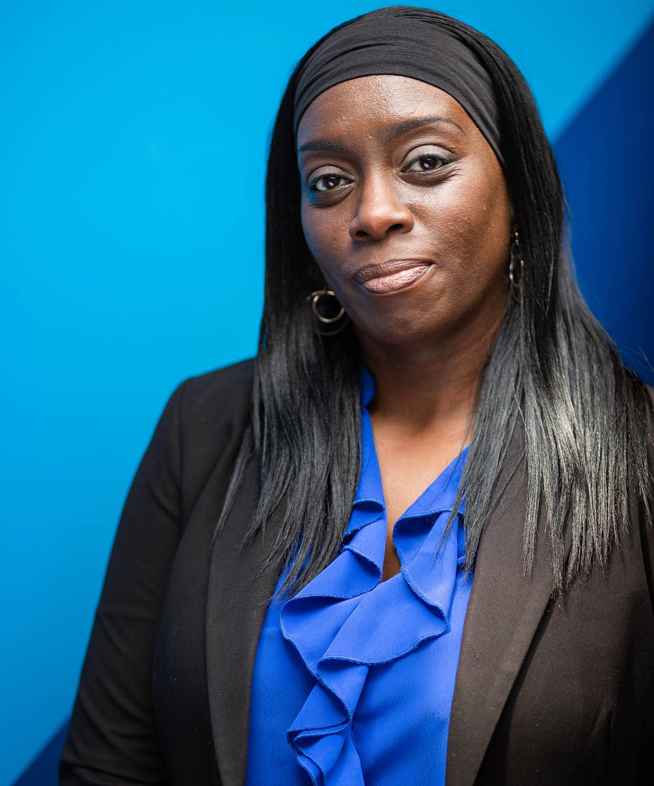 woman in black jacket on a blue background