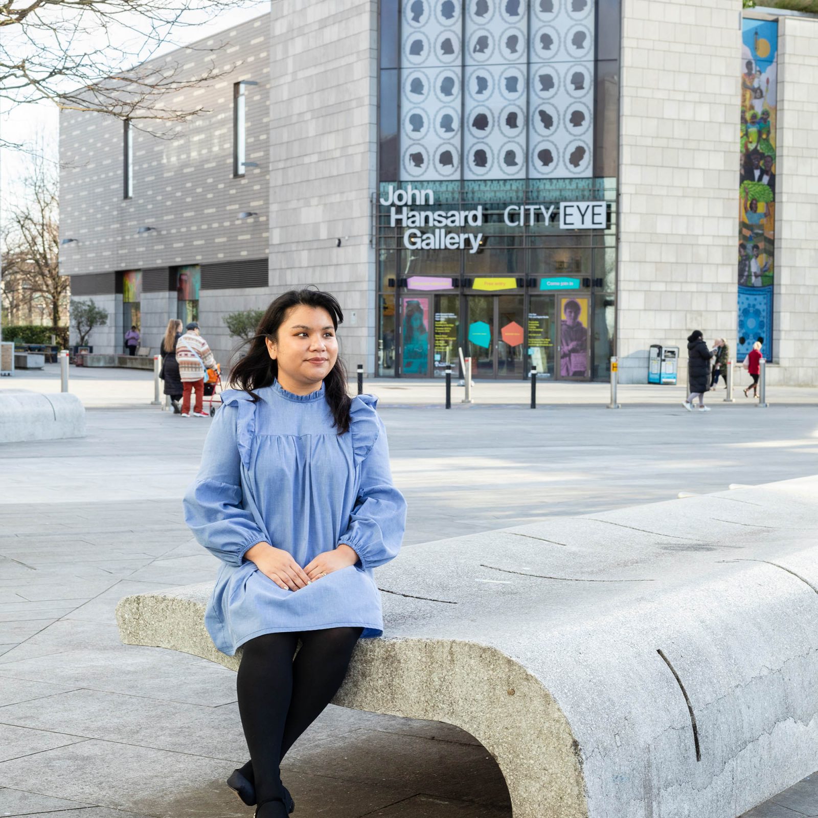 woman sitting on a stone bench