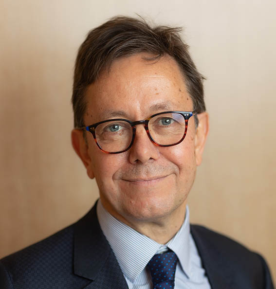 Portrait of a man wearing a blue shirt and tie